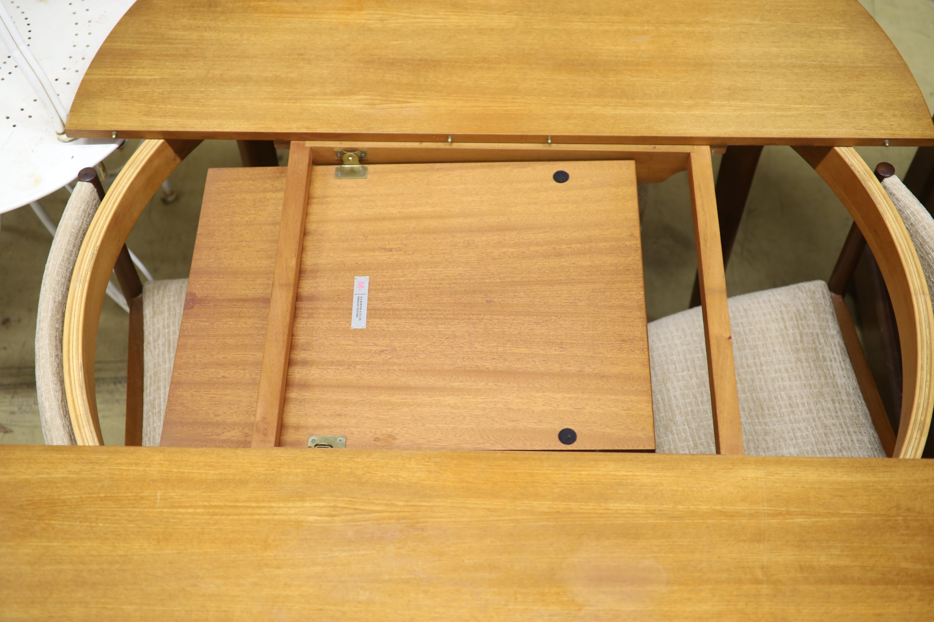 A mid century design Macintosh circular teak extending dining table and four chairs, model 9533, table width 170cm extended depth 122cm height 74cm